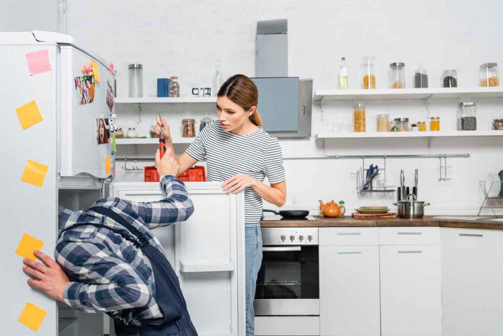 A-technician-checking-a-Maytag-fridge-for-diagnostic-fee